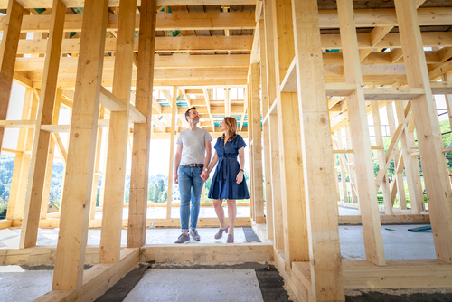 a couple looking at the progress of their new construction