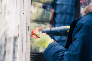 man drilling in the cold