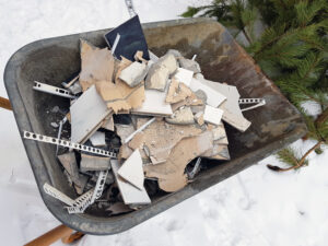 drywall in a wheelbarrow in winter